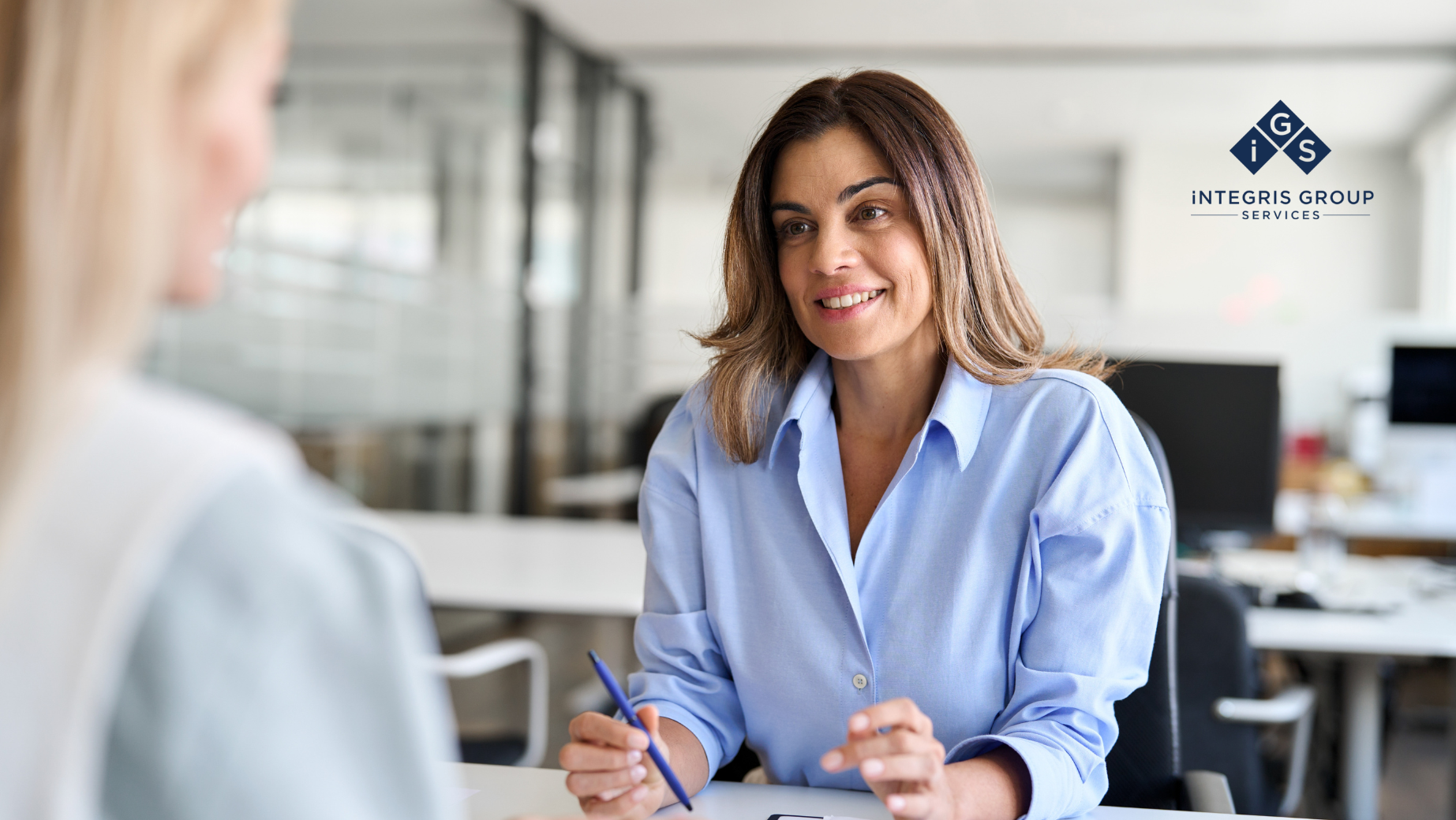 Empathetic female leader engaging in a supportive conversation with a team member.