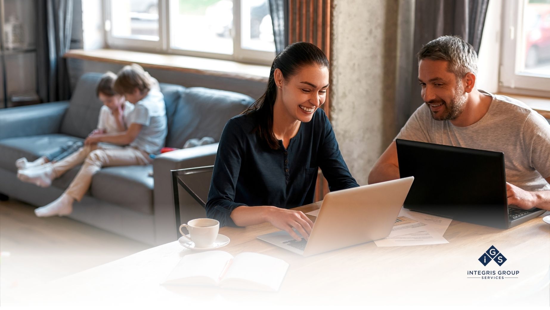 Work-life balance leadership: professionals working from home with family in the background.