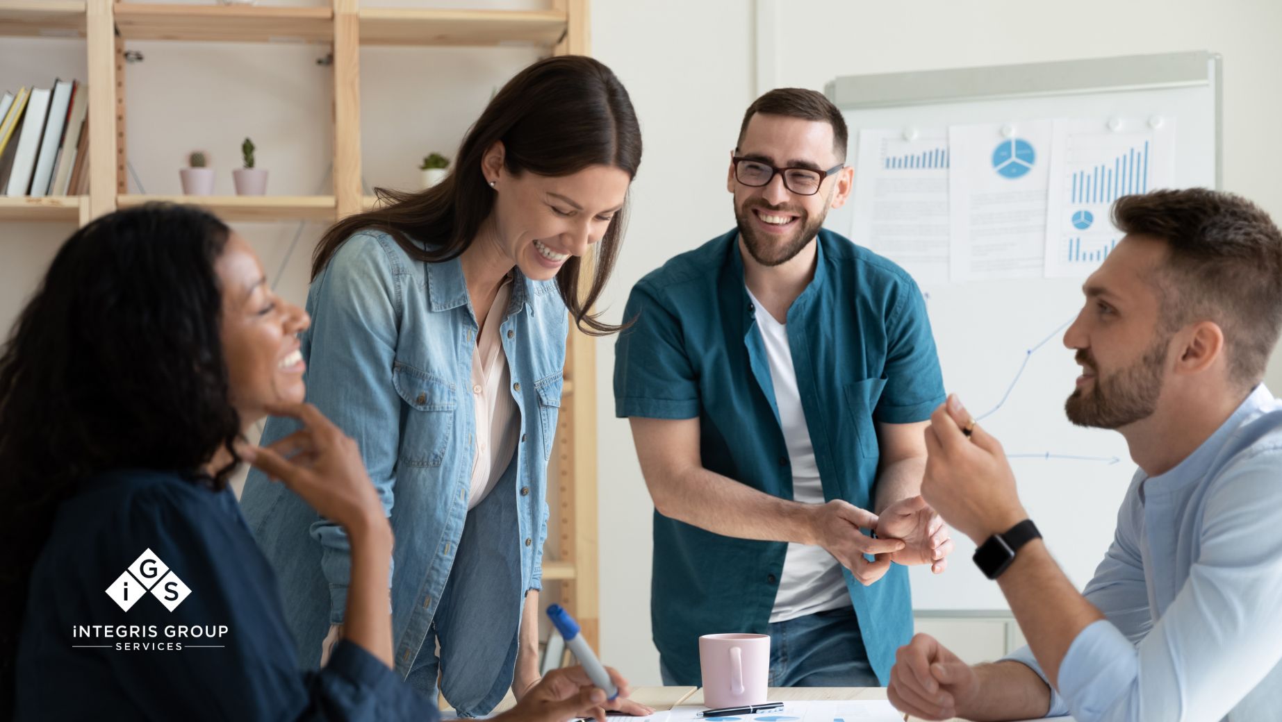 A diverse team of professionals smiling and collaborating in a modern office, highlighting positive client collaboration at Integris Group Services.