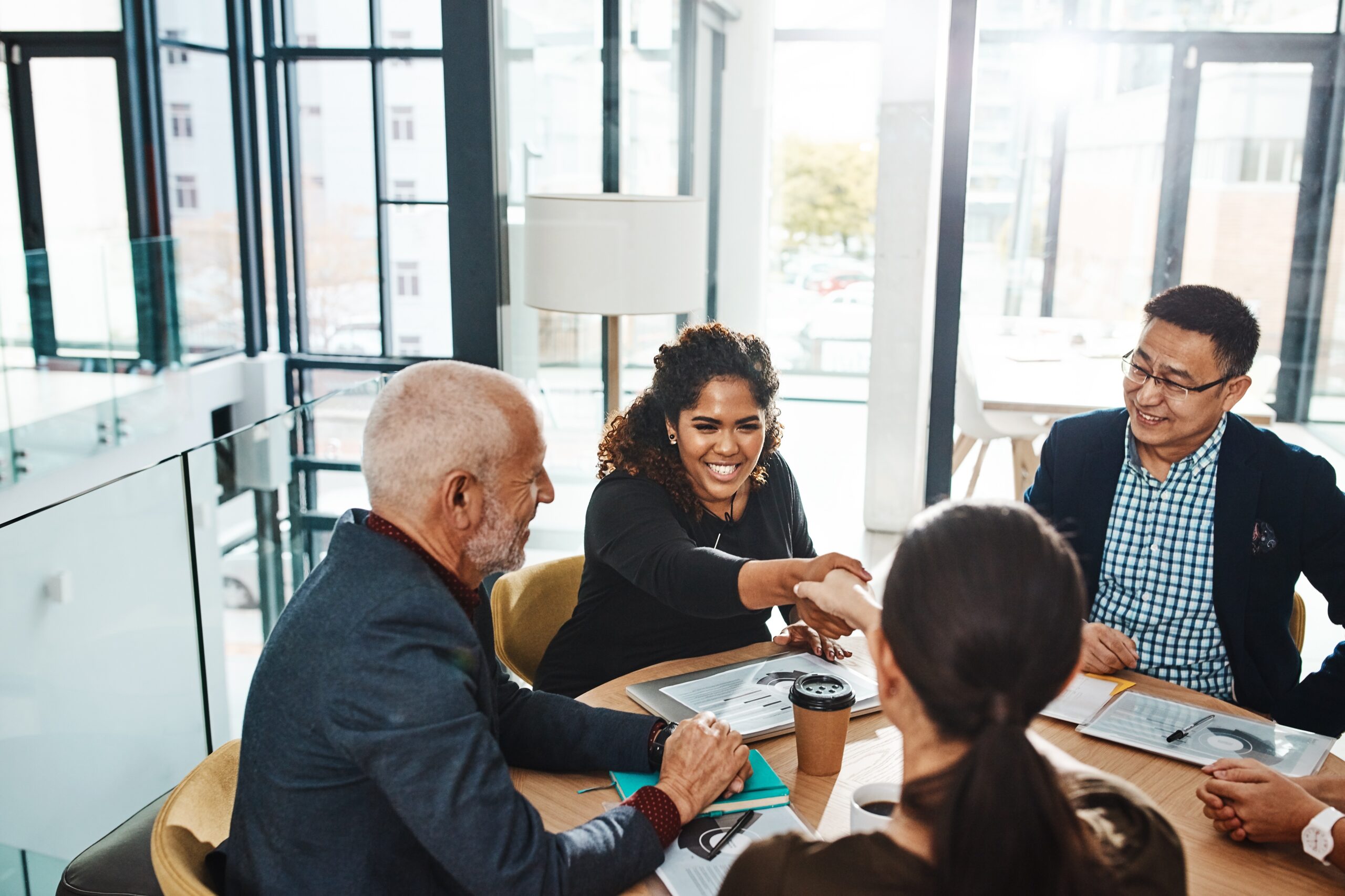 Professionals shaking hands, showcasing values-driven leadership